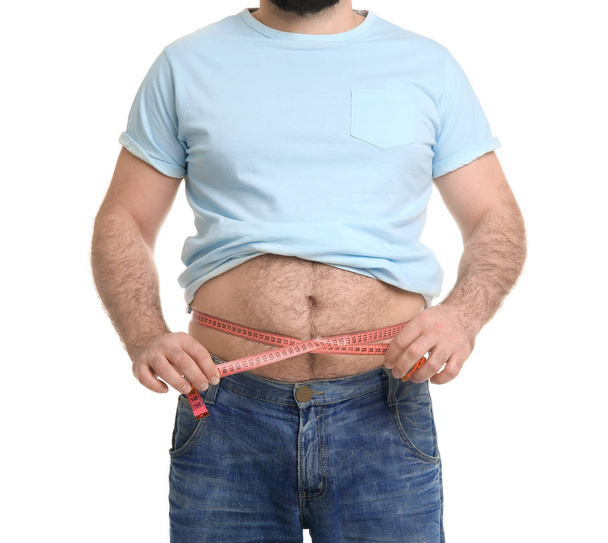 Overweight man with measuring tape on white background - Foto, imagen