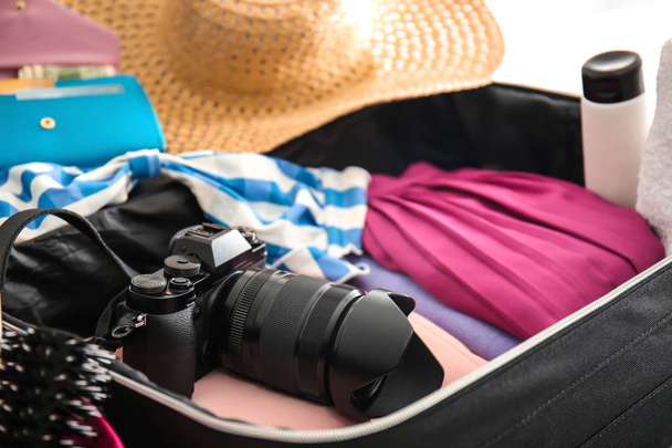 Open suitcase with packed things, closeup - Foto, Imagen