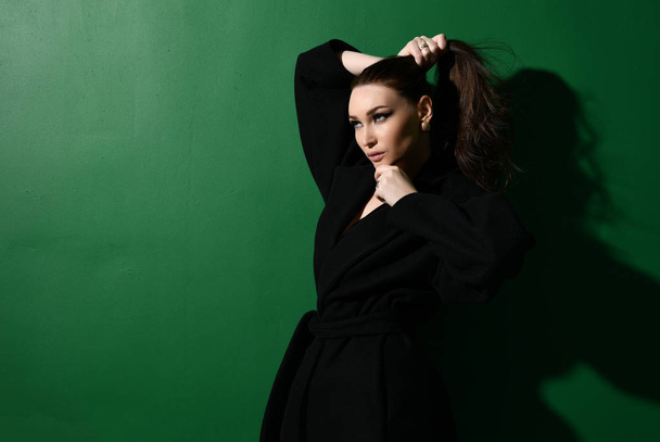 Beautiful brunette woman with long hair posing on green mint - Fotografie, Obrázek