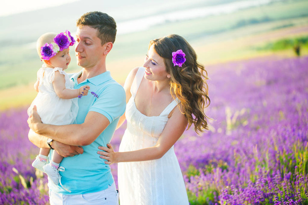 Young family in a lavender field - Φωτογραφία, εικόνα