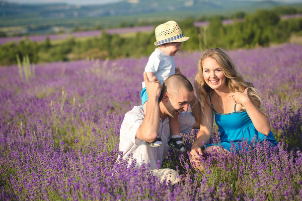 Young family in a lavender field - Fotó, kép