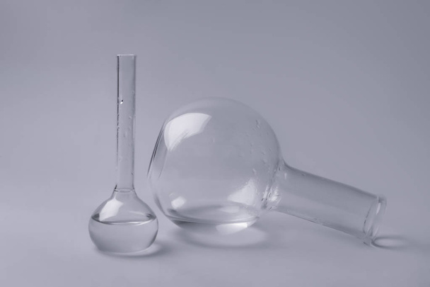 Volumetric flasks with liquid on grey background - Foto, Imagem