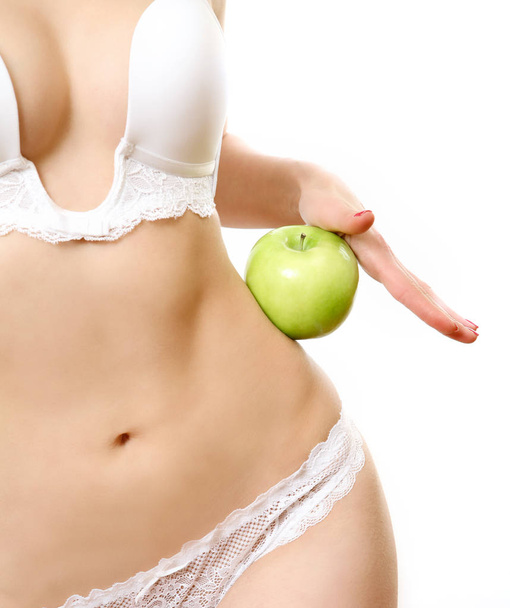 Woman with green apple at slim weist - Фото, зображення