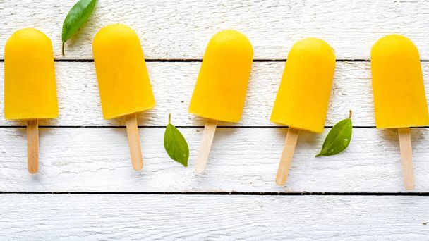 Orange popsicles with juice. Ice pops, flat lay, top view - Photo, Image