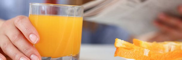 Beautiful woman hold in arms glass of orange juice - Φωτογραφία, εικόνα