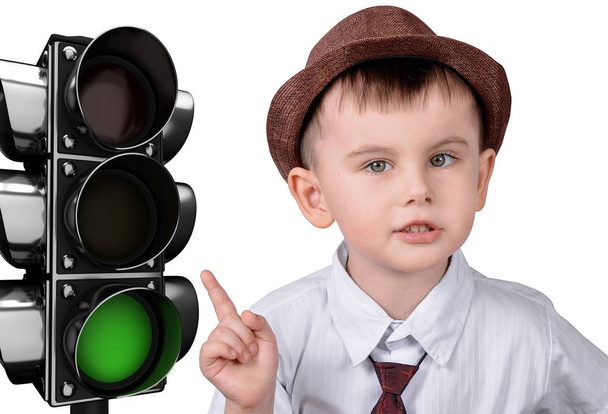 A little boy is pointing at a traffic light. The concept of traffic rules - Fotoğraf, Görsel