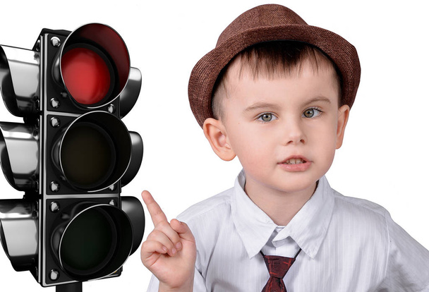 A little boy is pointing at a traffic light. The concept of traffic rules - Fotó, kép