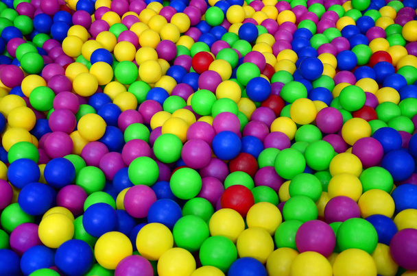 Molte palline di plastica colorate in una vasca da ballo per bambini in un parco giochi. Modello ravvicinato
 - Foto, immagini