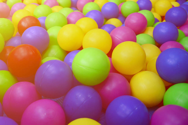 Viele bunte Plastikbälle in einem Kinderballkasten auf einem Spielplatz. Nahaufnahme - Foto, Bild