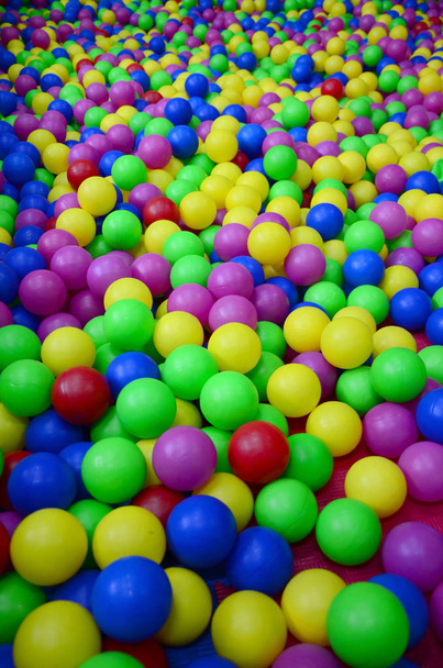 Many colorful plastic balls in a kids' ballpit at a playground. Close up pattern - Photo, Image