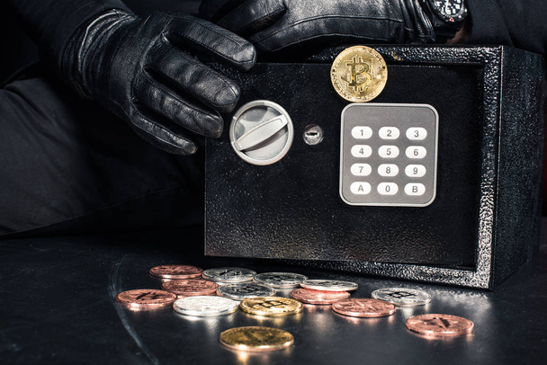 Close-up view of man opening safe with bitcoin cryptocurrency - Fotó, kép