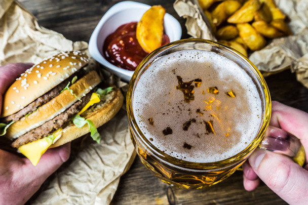 Fast food and a chilled glass of fresh light beer. - Foto, Imagen