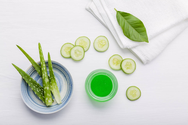 Natural herbal skin care products. Top view ingredients cucumber and aloe vera on table concept of the best all natural face moisturizer. Facial treatment preparation background. - Photo, Image