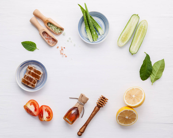 Natural herbal skin care products. Top view ingredients cucumber ,aloe vera ,lemon ,honey ,himalayan salt and tomato on table concept natural face moisturizer. Facial treatment preparation background - Photo, Image