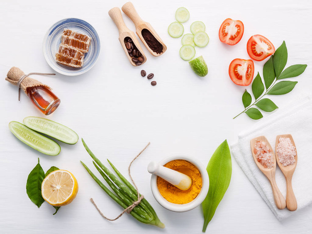 Natural herbal skin care products. Top view ingredients cucumber ,aloe vera ,lemon ,honey ,himalayan salt and tomato on table concept natural face moisturizer. Facial treatment preparation background. - Photo, Image