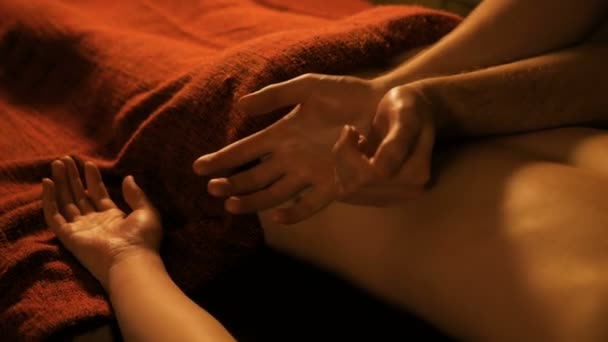 Masseur doing back massage for female client in spa center - Filmati, video