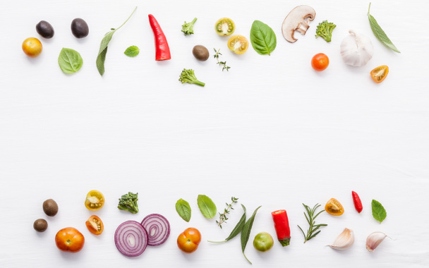 Various fresh vegetables and herbs on white background.Ingredients for cooking concept sweet basil ,tomato ,garlic ,pepper and onion with flat lay. - Fotó, kép