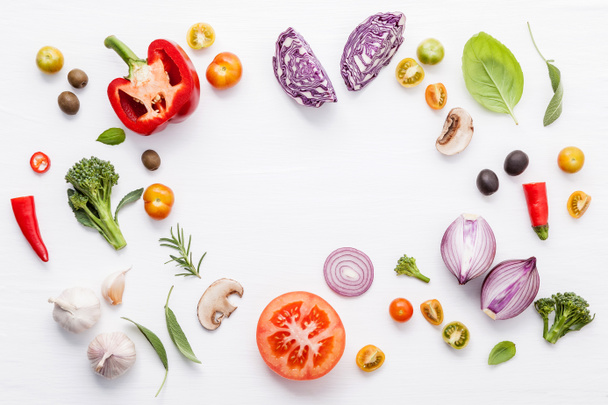 Various fresh vegetables and herbs on white background.Ingredients for cooking concept sweet basil ,tomato ,garlic ,pepper and onion with flat lay. - Photo, Image