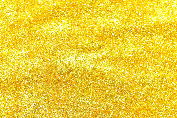 goldene Glitzertextur farbenfroher verschwommener abstrakter Hintergrund für Geburtstag, Jahrestag, Hochzeit, Silvester oder Weihnachten. - Foto, Bild