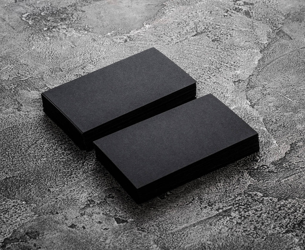Stacks of black blank business cards on textured background - Fotografie, Obrázek