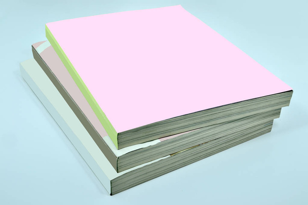 Stack of three thick magazines or books, catalogs with blank pin - Photo, Image