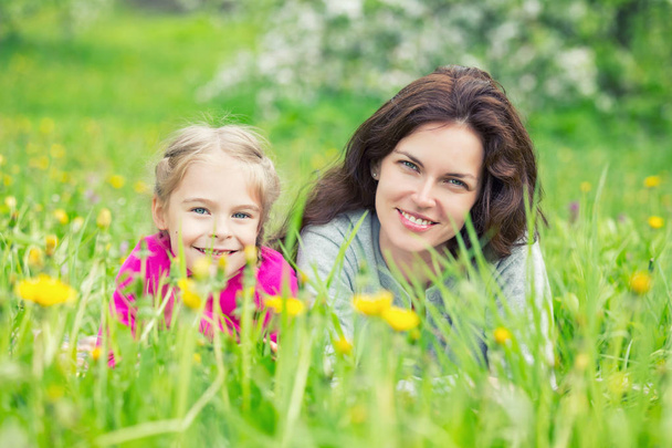 Mother and daughter on green summer meadow - Φωτογραφία, εικόνα