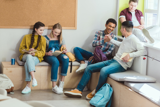 Multicultural group of high school teenage students reading books during school break  - Fotografie, Obrázek