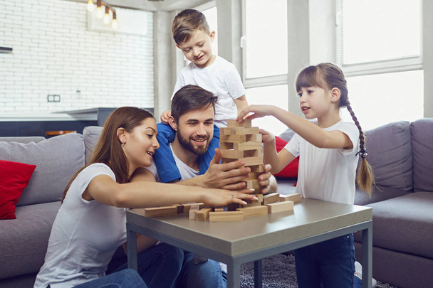 Happy family playing board games at home. - Фото, изображение