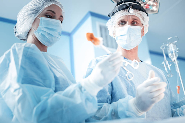 Professional smart doctors performing a surgery - Фото, зображення