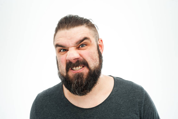 Closeup portrait of angry, mad, annoyed, skeptical, grumpy man, employee, worker isolated on white background. Human emotions, face expressions, reaction, interpersonal conflict resolution - Photo, image