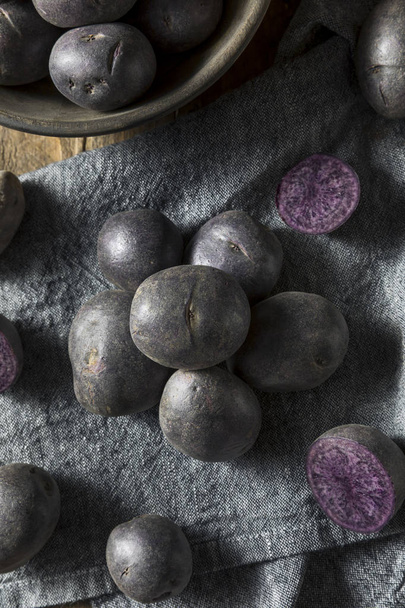 Raw Organic Purple Baby Potatoes - Photo, image