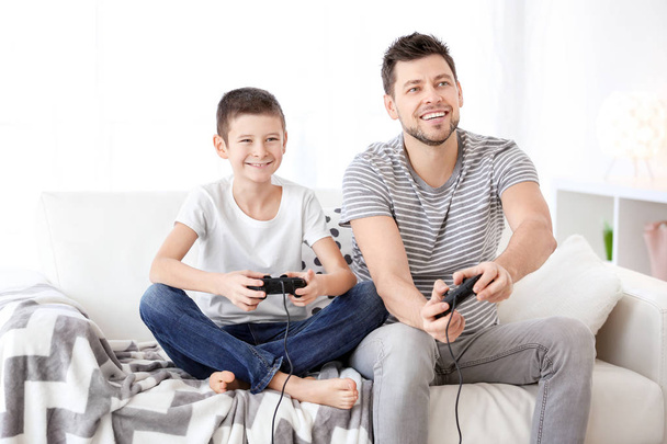 Young man playing video games isolated on white - Foto, Imagen