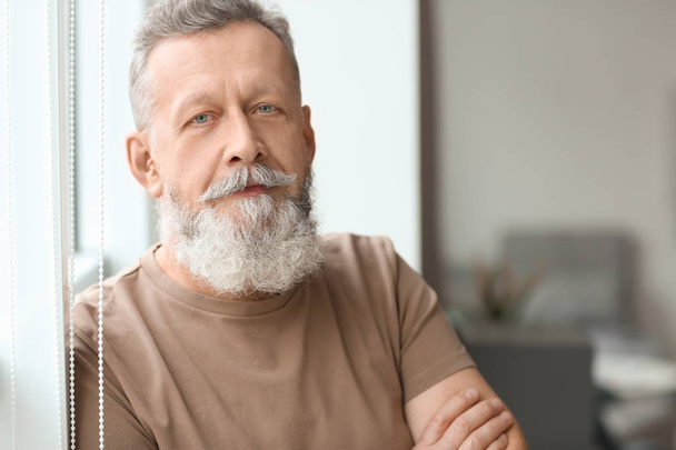 Portrait of handsome mature man at home - Photo, Image
