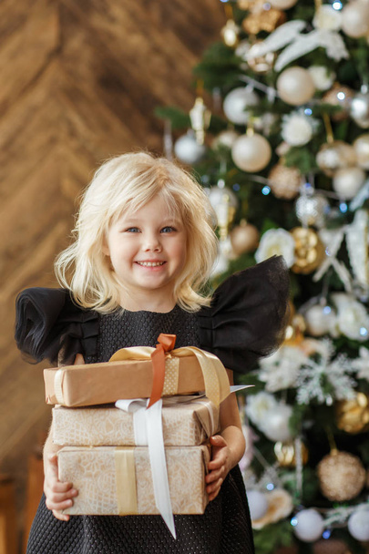 Little blonde girl with christmas presents - Fotó, kép
