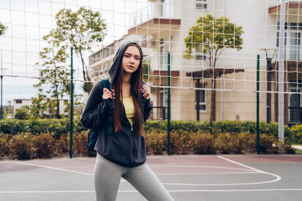 energetic young girl in sportswear actively engaged in sports, street training and inspiration - Fotografie, Obrázek