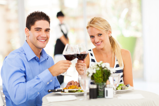 Young couple drinking wine in restaurant - Foto, Imagen