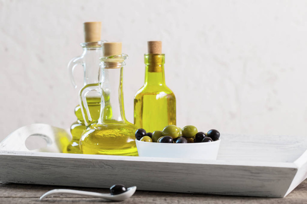 Olive oil  on the wooden table - Fotó, kép