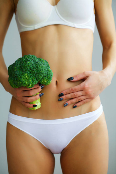 Close Up Of Woman In Underwear Holding Bunch Of Broccoli And Tou - Photo, image
