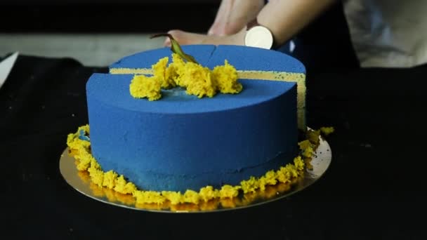 кондитерские руки срубили современный синий круглый торт украшенный сушеной грушей и кусочками желтого бисквита на части и показать один
 - Кадры, видео