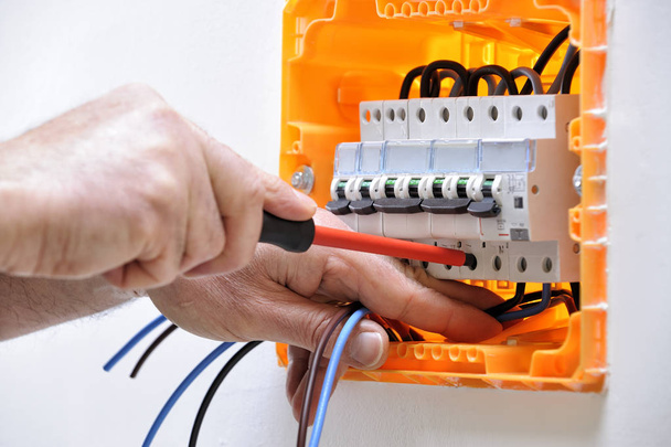 Technicien électricien au travail sur un panneau électrique résidentiel
 - Photo, image