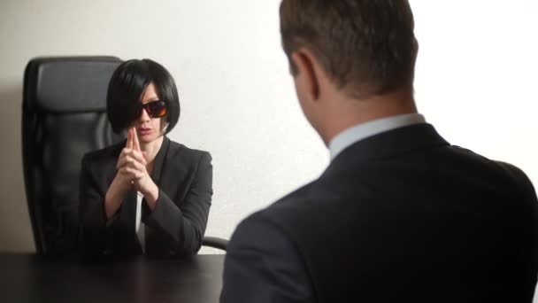 een brunette vrouw in een pak vragen aan een man in een interview. 4 k. interview. werving - Video