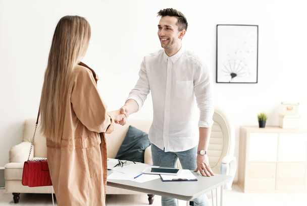 Human resources manager shaking hands with applicant during job interview in office - Foto, immagini