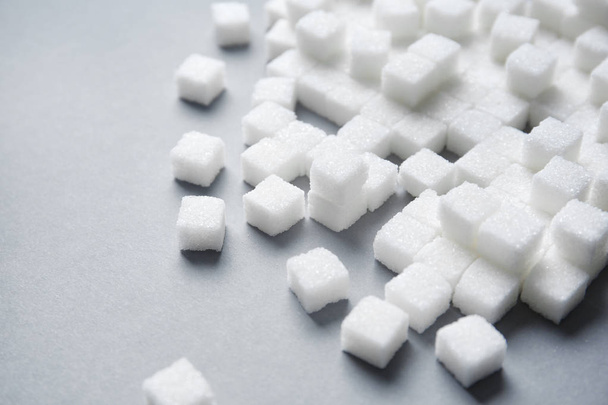 Refined sugar cubes on grey background - Фото, зображення