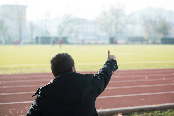 Back View of Young Excited Man on Bleachers - Fotoğraf, Görsel
