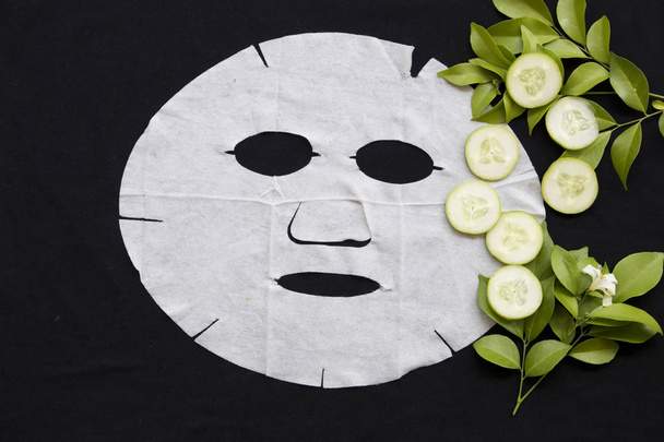 natural de la hoja de la máscara de cuidado de la salud para la cara de la piel el brillo del pepino en el fondo negro
 - Foto, imagen