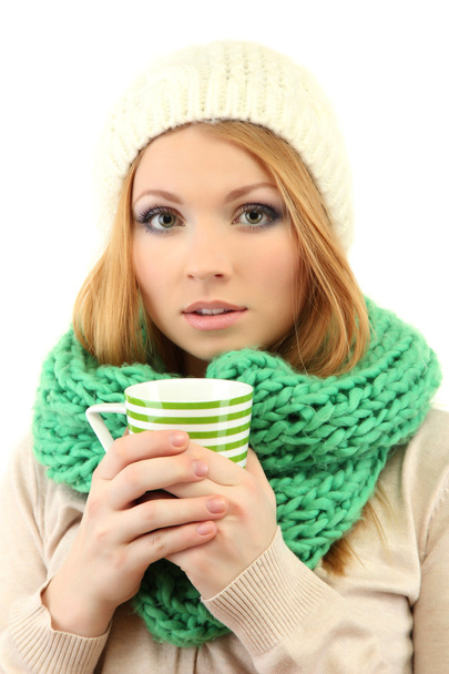 Attractive young woman holding cup with hot drink, isolated on white - 写真・画像