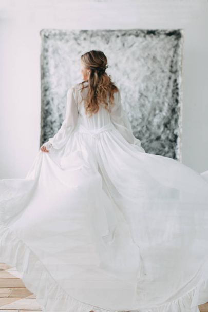 Beautiful young bride in boudoir dress on canvas background with paint. Wedding trends and ideas 2018, spring inspiration. Wedding in the Studio - Foto, immagini
