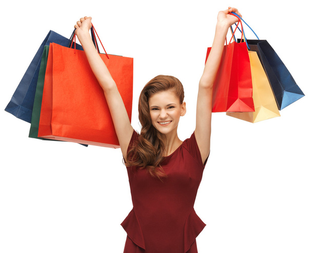Teenage girl in red dress with shopping bags - Foto, Imagem