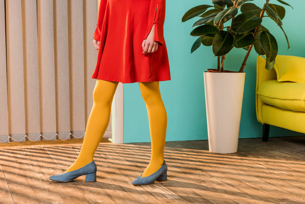 cropped shot of woman in bright clothing standing at colorful room, doll house concept - 写真・画像