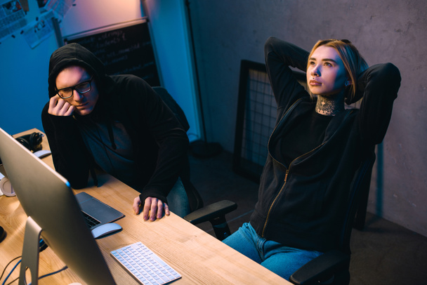 couple of thoughtful young hackers at workplace - Photo, Image